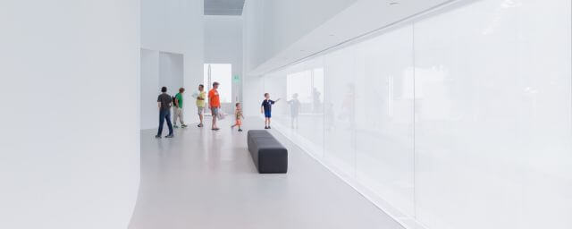 Inside of the Art + Design Building, with guests in the gallery