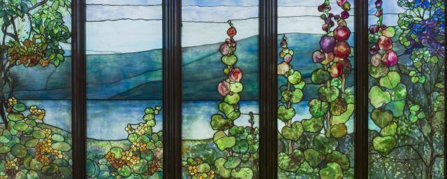 Stained glass view of a lake and flowers