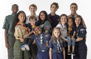 Group of Boy Scouts of various ages in full uniforms